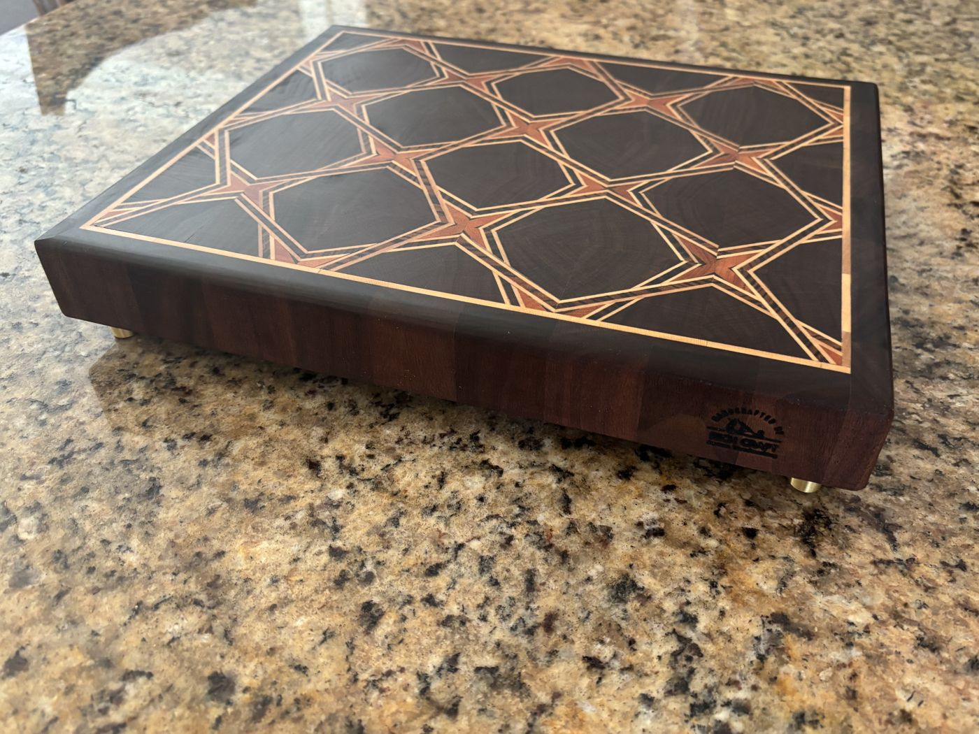 End-grain walnut cutting board with a geometric pattern
