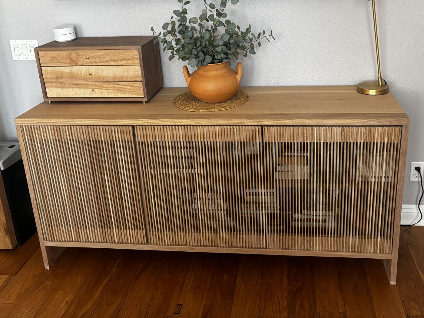 White oak media console with three slatted doors